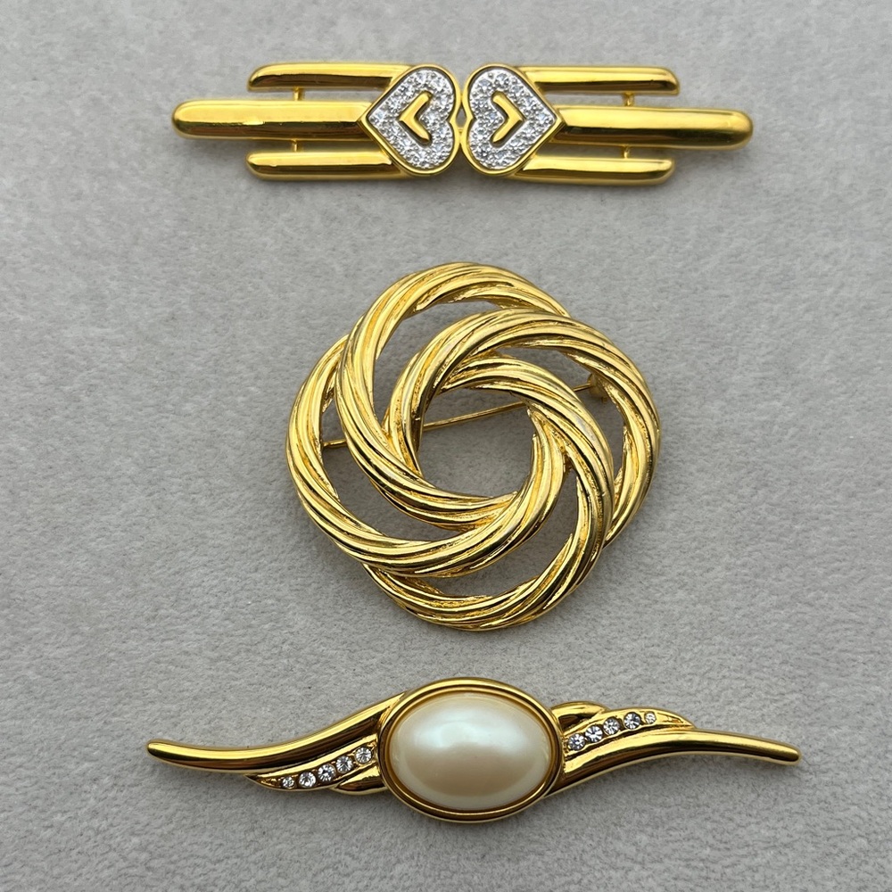 Lot of 3 vintage Monet gold tone brooches, 2 with rhinestones, 1 faux pearl